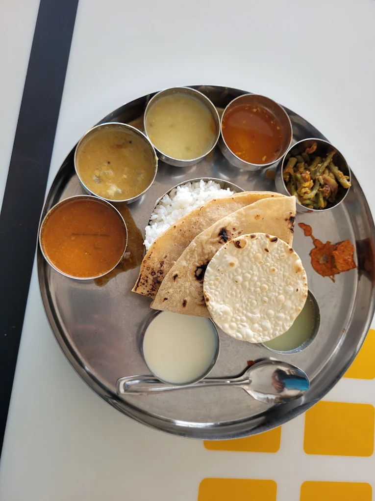 South Indian meals thali with rice, chapati, papad and katoris of curry