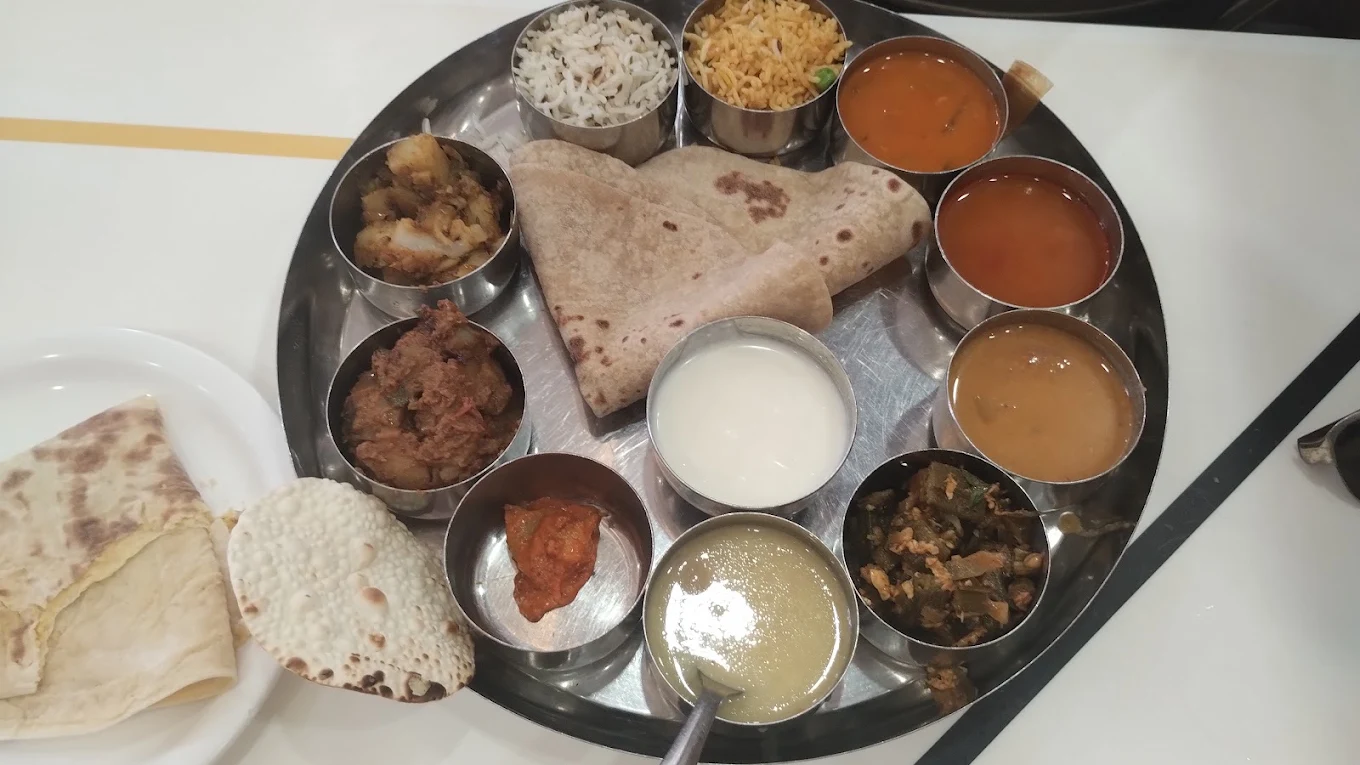 An elaborate deluxe thali with chapati, curd, papad and many curries